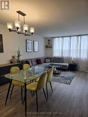 Toronto (Victoria Village) condo for rent - A well-lit living room with a glass table and yellow chairs.