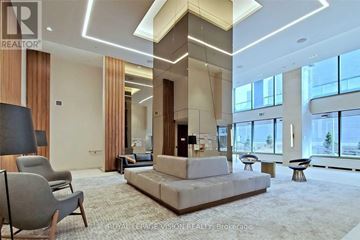 Toronto (Flemingdon Park) condo for rent - A spacious living room with a large sofa set and a view of the city.