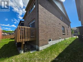 Springwater (Midhurst) apartment for rent - A brick house with a wooden deck in front.