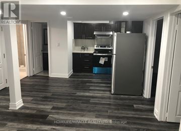 Mississauga (Meadowvale Village) apartment for rent - A kitchen with a refrigerator, stove, and cabinets.