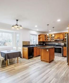 Surrey apartment for rent - A kitchen with wooden cabinets and a black countertop.