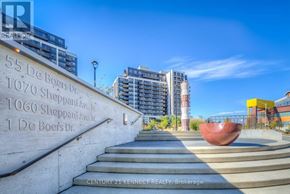 Toronto (York University Heights) condo for rent - A concrete staircase with a red bowl at the bottom and a building in the background.