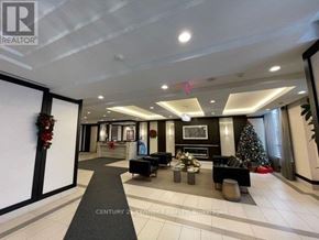 Toronto (York University Heights) condo for rent - A well-lit, modern living room with a Christmas tree and a fireplace.