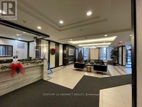Toronto (York University Heights) condo for rent - A well-lit lobby with a Christmas tree and a reception desk.