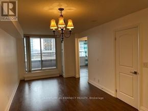 Toronto (York University Heights) condo for rent - A room with a chandelier and a door.