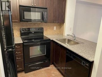 Toronto (York University Heights) condo for rent - A kitchen with a black oven and microwave.