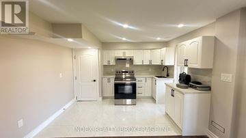 Mono apartment for rent - A spacious kitchen with white cabinets and appliances.