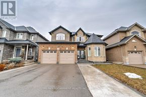 Hamilton (Stoney Creek) apartment for rent - A large, well-maintained house with a driveway in front.