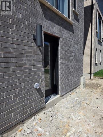 Waterloo apartment for rent - A brick wall with a small doorway and a window.