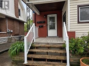 Welland (Welland Downtown) triplex for rent - A house with a red door and a white railing.