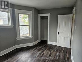 Welland (Welland Downtown) triplex for rent - A room with grey walls and a white door.