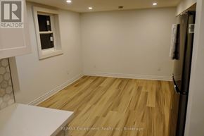 Toronto (Regent Park) townhouse for rent - A room with a wooden floor and a window.