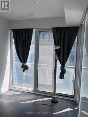Toronto (Church-Yonge Corridor) condo for rent - A room with a large window and curtains.