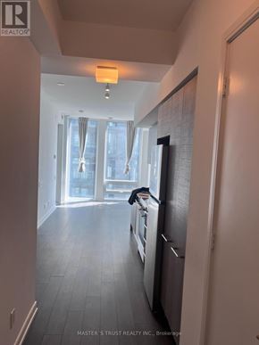 Toronto (Church-Yonge Corridor) condo for rent - A hallway with a light on the ceiling and a door on the right.
