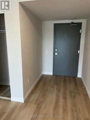 Guelph (Grange Road) condo for rent - A room with a grey door and wooden flooring.