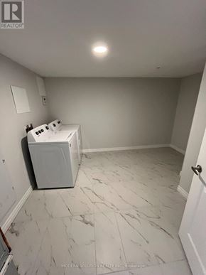 Guelph (Grange Road) condo for rent - A room with a washer and dryer in it.