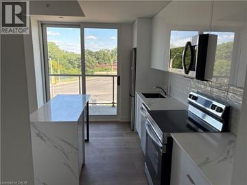 Brantford condo for rent - A kitchen with a marble countertop and stainless steel appliances.