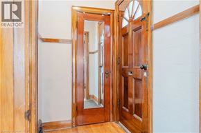 Hamilton apartment for rent - A wooden door with a glass panel is open.