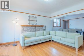 Hamilton apartment for rent - A living room with a white couch and a wooden floor.
