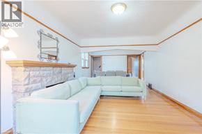 Hamilton apartment for rent - A living room with a white couch and a stone fireplace.
