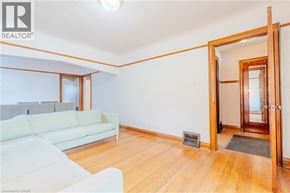 Hamilton apartment for rent - A living room with a white couch and a wooden floor.