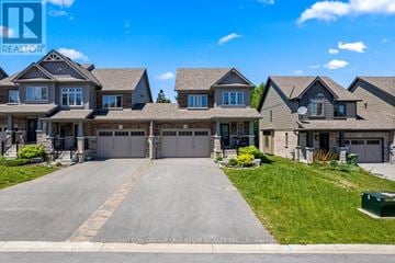 Grey Highlands townhouse for rent - A large, well-maintained house with a driveway in front is for sale.