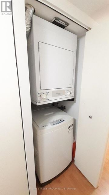 Toronto (Bay Street Corridor) condo for rent - A white dryer is in a small closet.