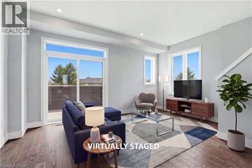London townhouse for rent - A living room with a blue couch and a glass coffee table.