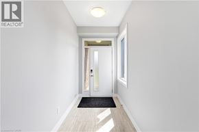 London townhouse for rent - A hallway with a door and a mat on the floor.