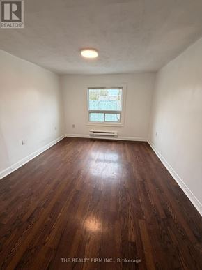 London East (East M) duplex for rent - A room with wooden flooring and a window.