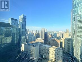 Toronto (Bay Street Corridor) condo for rent - A cityscape with skyscrapers and a clear sky.