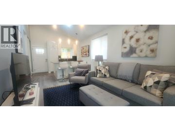 Vancouver apartment for rent - A living room with a grey couch and a television.
