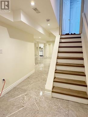Vaughan (Maple) apartment for rent - A staircase with a red hose on the floor.