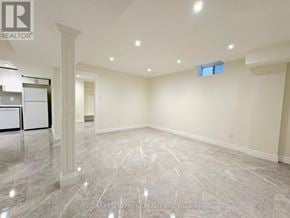 Vaughan (Maple) apartment for rent - A spacious room with marble flooring and a pillar in the middle.