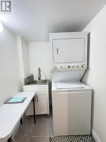 Vaughan (Maple) apartment for rent - A small white kitchen with a sink and a stove.