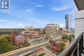 Kitchener condo for rent - A cityscape with buildings and a clear sky.