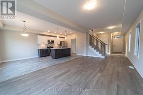 Thorold (Rolling Meadows) apartment for rent - A spacious room with a staircase and a kitchenette.