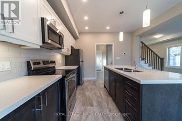 Thorold (Rolling Meadows) apartment for rent - A modern kitchen with dark wood cabinets and stainless steel appliances.