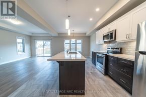 Thorold (Rolling Meadows) apartment for rent - A spacious kitchen with dark wood floors and stainless steel appliances.