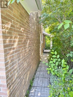 Toronto (Don Valley Village) apartment for rent - A brick wall with a pathway leading to a door.