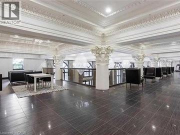 Hamilton condo for rent - A living room with a grey couch and a wooden coffee table.