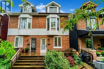 Toronto (South Riverdale) apartment for rent - A house with a brick facade and a black awning.