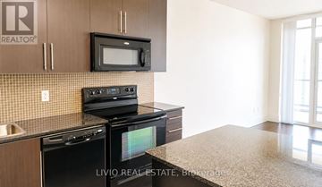 Mississauga (City Centre) condo for rent - A kitchen with a black microwave above the stove.