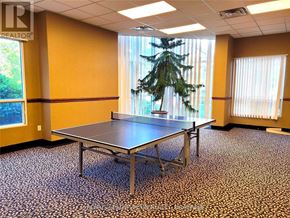 Toronto (Banbury-Don Mills) condo for rent - A table tennis table is in a room with a tree in the window.