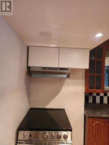 Mississauga (Lisgar) apartment for rent - A kitchen with a black stove top and white cabinets.