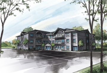 Mora apartment for rent - A large, modern building with a parking lot in front.