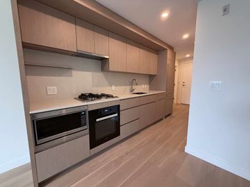 Vancouver apartment for rent - A kitchen with a stove top oven and microwave.