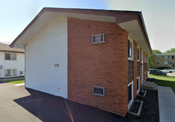 North Saint Paul apartment for rent - A brick house with a white garage door.