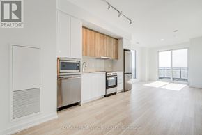 Markham (Greensborough) condo for rent - A modern kitchen with stainless steel appliances and wooden cabinets.
