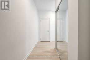 Markham (Greensborough) condo for rent - A hallway with a door and a mirror on the wall.